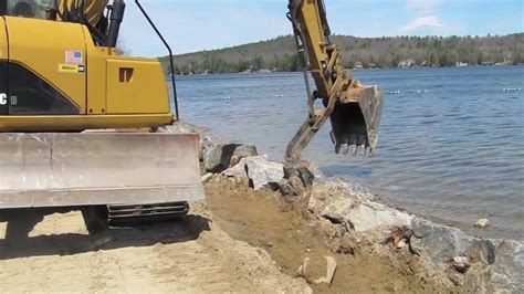 Mini Excavator Moving Rocks 